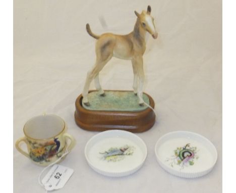 A Royal Worcester figurine "Thoroughbred foal", designed by Doris Lindner and raised on wooden stand, together with framed li