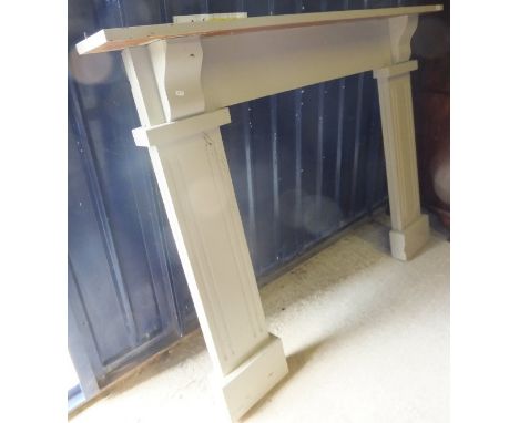 A modern painted wooden fire surround
