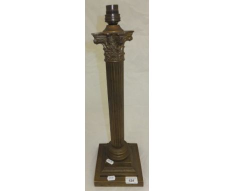 A brass bodied table lamp in the form of column