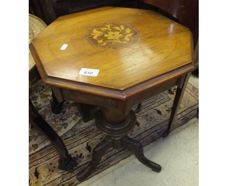 A Victorian walnut trumpet shaped work table with fitted interior on a hipped tripod base