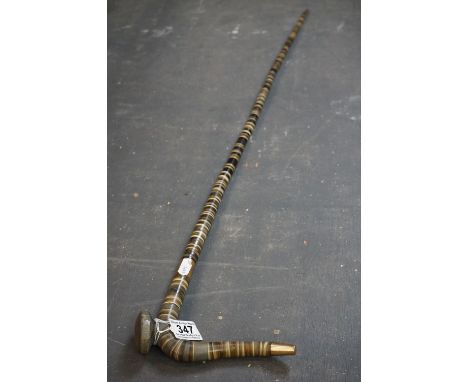 A early 20th century horn washer walking stick with yellow metal band. 