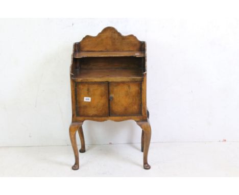 20th century Queen Anne style Walnut Cabinet, the shaped back with shelf above two door cupboard raised on cabriole legs, 49c