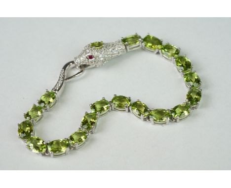 Silver CZ &amp; peridot line bracelet, set with a snake head clasp set with ruby eyes 