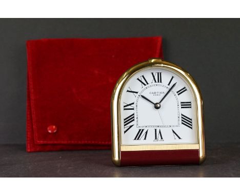 A Cartier Swiss made travel alarm clock No.08058 together with protective red bag.