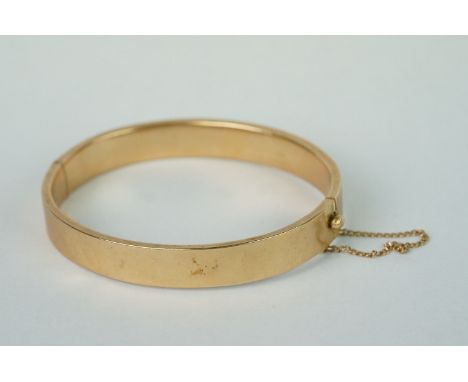 A fully hallmarked 15ct gold ladies cuff bangle with safety chain. 