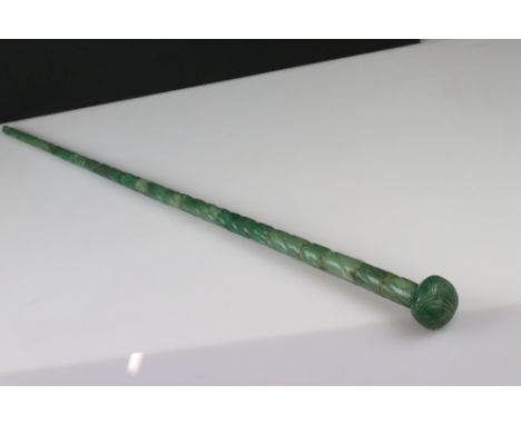 A carved green agate walking stick with decorative pommel. 