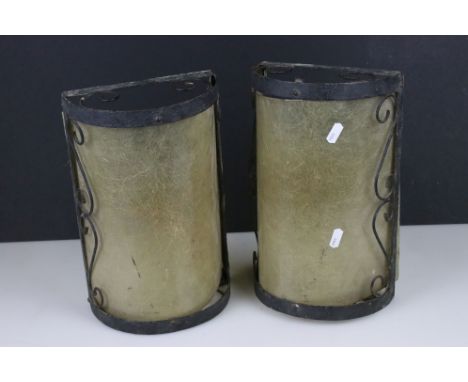 A pair of wrought iron exterior lamp shades. 