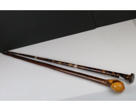 A faux tortoiseshell walking cane with mother of pearl banding together with a Wooden Pommel Head Walking Stick 