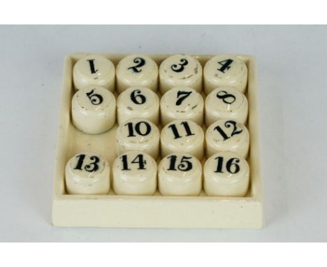 A set of 19th century ceramic gaming counters / teaching aids numbers 1 to 16 (one missing) on matching ceramic stand. 