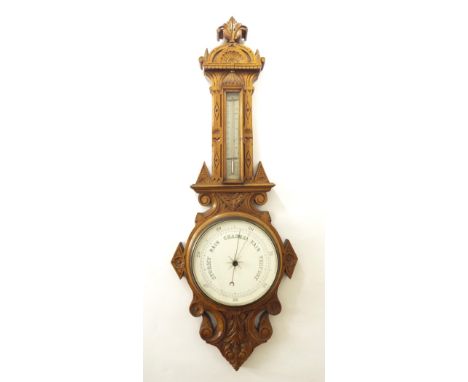 Light oak two glass barometer, the 8" dial within a carved oak case