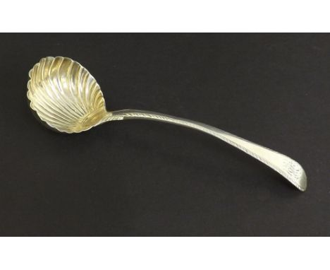 English 18th century silver soup ladle, with bright cut engraving and a parcel gilt scalloped bowl, maker TC (probably Thomas