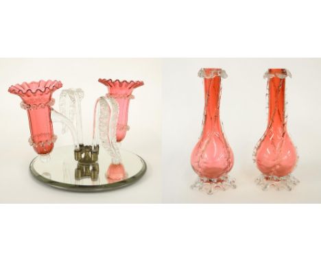 Victorian cranberry glass epergne with two spill vases and moulded leaf branches upon a circular bevelled mirrored base, 8.5"