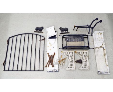 Metal items to include a pair of cast iron firedogs, painted iron gate, selection of iron brackets with figural decoration, t