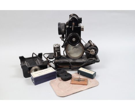 A Pathé Baby Projector, 9.5mm, body G, elements F-G, glass panel in tact, with various bulbs, film cartridges, manual, power 
