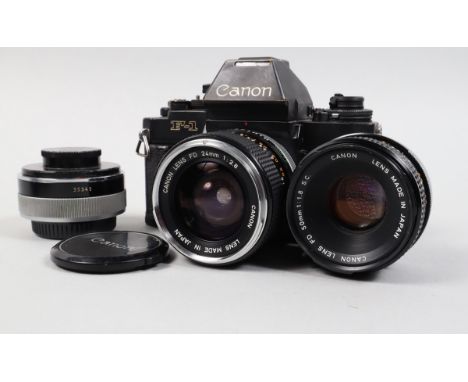 A Canon F-1N SLR Camera, serial no 174108, shutter working, meter responsive, body G, brassing to edges, with 24mm f/2.8 FD l