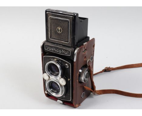 A Yashica Mat TLR Camera, shutter sluggish/sticking on slow speeds, body F-G, ding to front edge, scratches to edges, with 80