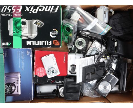 A Tray of Compact Digital Cameras, manufacturers include Minox, Casio, Fujifilm, Polaroid, other examples, some cables, charg