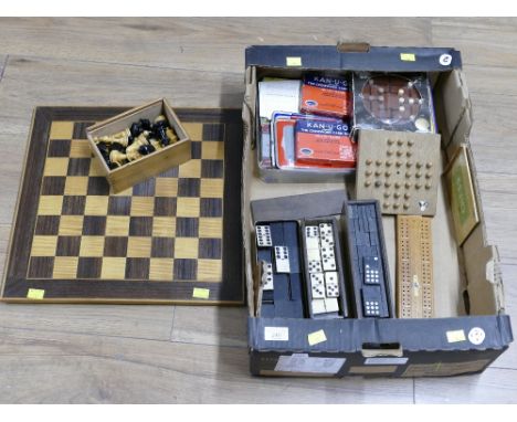 Wooden chessboard and box of games pieces, draughts, chess pieces, etc