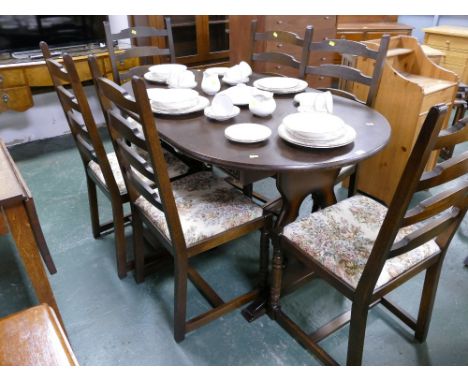 Dark oak extending oval table and six ladder back chairs