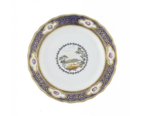 A DERBY PLATE, C1785 painted by Zachariah Boreman with a central landscape, the border with moulded panels each painted with 