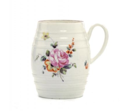 A DERBY BARREL SHAPED MUG, C1770 painted in polychrome with sprays and scattered flowers, 9.5cm h ++Some light wear to the br