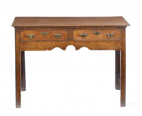 A GEORGE III OAK SIDE TABLE, EARLY 19TH C 71cm h; 54 x 101cm ++Brass handles and the lock to one of the drawers old replaceme