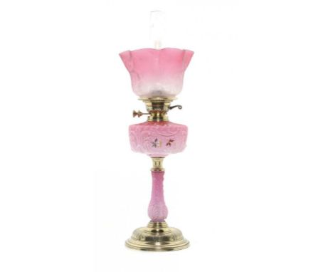 A VICTORIAN BRASS AND SHADED AND MOULDED PINK GLASS OIL LAMP, C1880  enamelled with flowers, brass Duplex burner, with etched