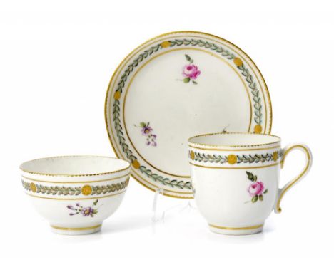 A DERBY TRIO, C1784-88  enamelled with scattered flowers beneath laurels and cisélé gilding, saucer 12 diam, gilt anchor and 