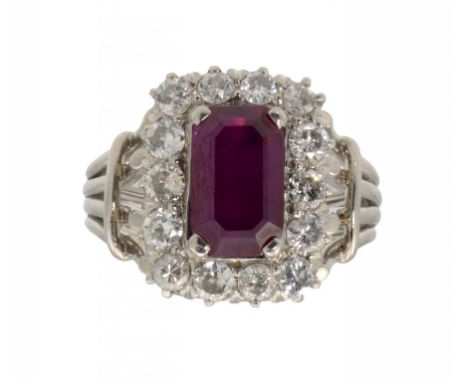 A STEP CUT RUBY AND DIAMOND CLUSTER RING, C1970   in white gold wirework, size N, 6.7g gross ++In fine condition