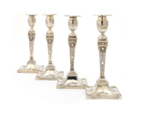 A SET OF FOUR EDWARD VII NEO CLASSICAL STYLE SILVER CANDLESTICKS  with nozzles  26cm h, by Hawksworth, Eyre & Co Ltd, Sheffie