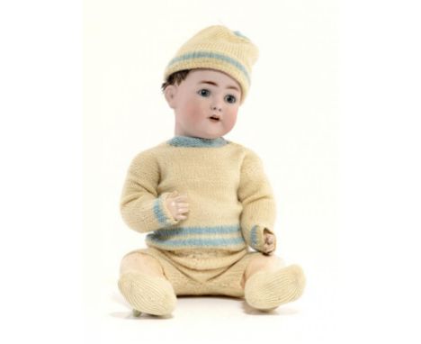 A FRANZ SCHIMDT BISQUE HEADED CHARACTER BOY DOLL, C1900  with blue glass sleeping eyes and five piece composition body, 55cm 