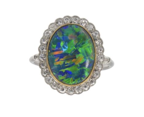 A BLACK OPAL AND DIAMOND CLUSTER RING  in white gold,  gross weight 5.9g, size R ++A very attractive ring in fine condition