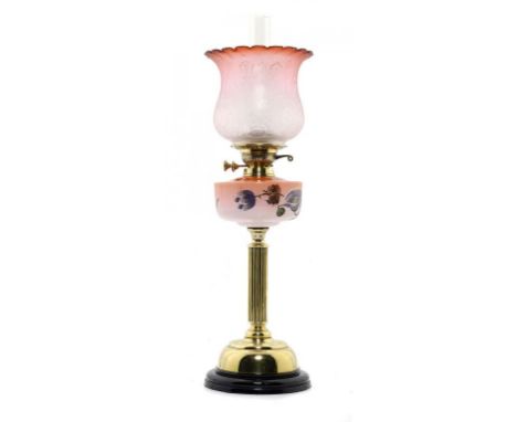 A VICTORIAN BRASS COLUMNAR OIL LAMP  the shaded pink glass fount enamelled with flowers, brass Duplex burner, etched glass sh