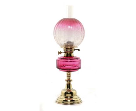 A VICTORIAN BRASS OIL LAMP, c1890  with faceted cranberry glass fount, brass Duplex burner, etched cranberry glass shade, 52c