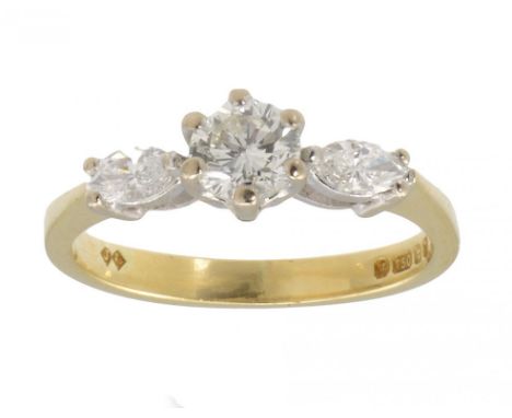 A DIAMOND RING  with larger central round brilliant cut diamond in 18ct gold, London 1989, size K, 3.1g gross ++In fine condi