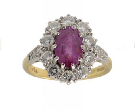 A RUBY AND DIAMOND CLUSTER RING  with diamond shoulders, in 18ct gold, Birmingham 1988, size P ++In very good second hand con