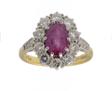 A RUBY AND DIAMOND CLUSTER RING  with diamond shoulders, in 18ct gold, Birmingham 1988, size P ++In very good second hand con