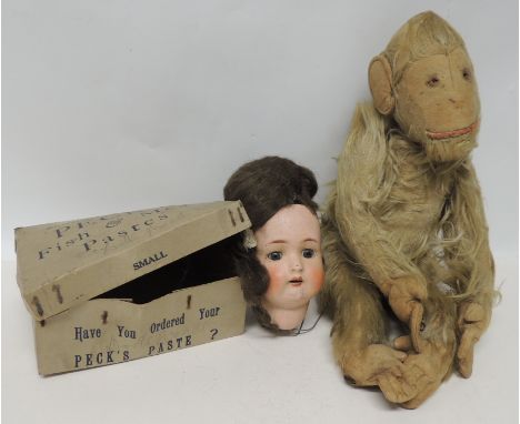 An early 20th Century soft toy monkey with long, light plush, felt face, hands and feet 44cms high together with an Armand Ma