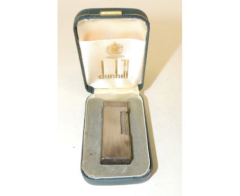 A Dunhill silver metal cased cigarette lighter in original box, the rectangular lighter with guilloche decoration