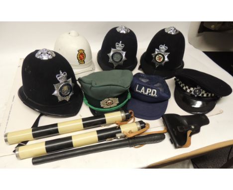 Three blue police helmets with badges - Avon & Somerset and two Metropolitan (Elizabeth II) together with other police caps a