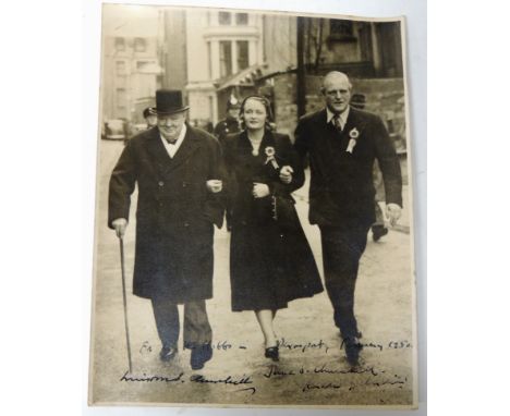 WINSTON CHURCHILL - a photograph of Sir Winston Churchill, Randolph Churchill and June Churchill walking arm in arm down a st