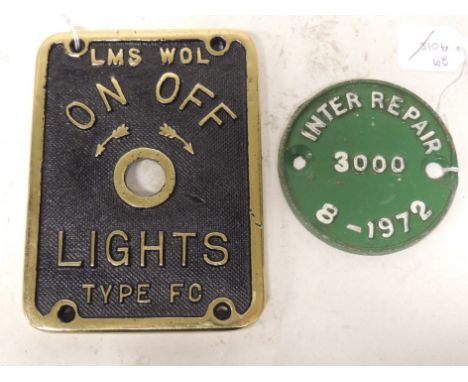 A cast brass LMS light switch plate "LMS Wol On Off Lights Type FC" 16.5cms x 12.5cms together with a cast metal disc "Inter 