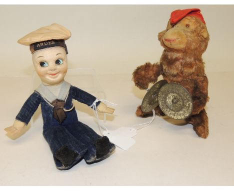 A c.1940's plush covered clockwork toy bear playing the cymbals, 17cms high and together with a small sailor doll soft toy wi