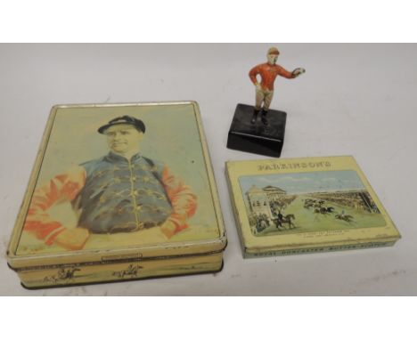 A painted metal figure of a jockey standing on black ceramic base with gilt "21" to the base, 12cms high and together with tw
