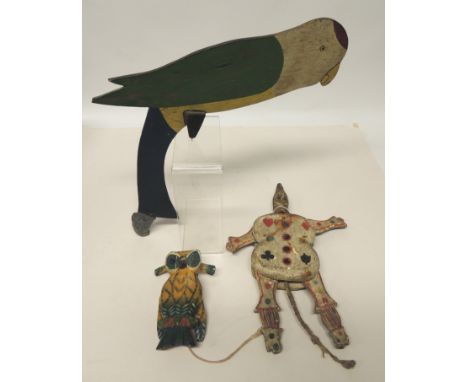 A 19th Century wooden automaton toy, painted gesso, double sided of a clown/soldier, rope extends from base, when pulled arms