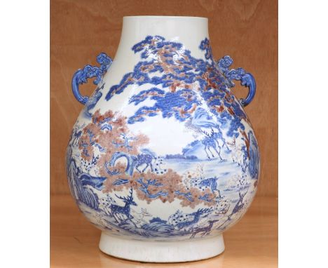 A LARGE CHINESE PORCELAIN TWO-HANDLED VASE,&nbsp;of ovoid form, painted with a continuous landscape of deer, prunus and mount