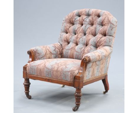 A VICTORIAN WALNUT AND UPHOLSTERED ARMCHAIR, with button back and short fluted tapering legs, moving on castors. Height of ba