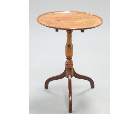 A GEORGE III MAHOGANY TRIPOD TABLE, the dished circular top raised on a ring turned stem continuing to downswept legs. 69cm h