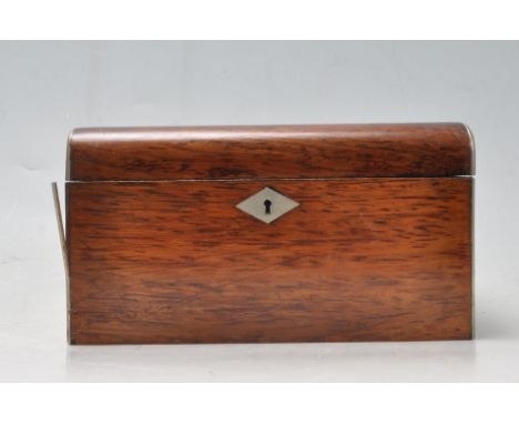 A 19th century Victorian rosewood tea caddy / box. The tea caddy of a rectangular form with rounded lead, tea notation insert