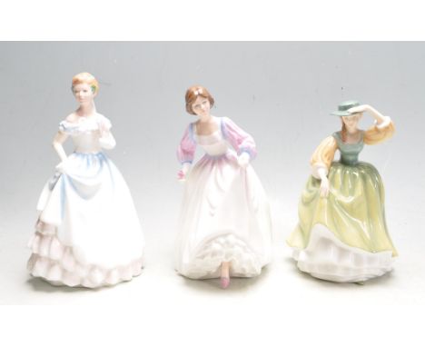 A collection of three vintage 20th century polychrome ceramic porcelain figurines comprising of Royal Doulton Pretty Ladies B